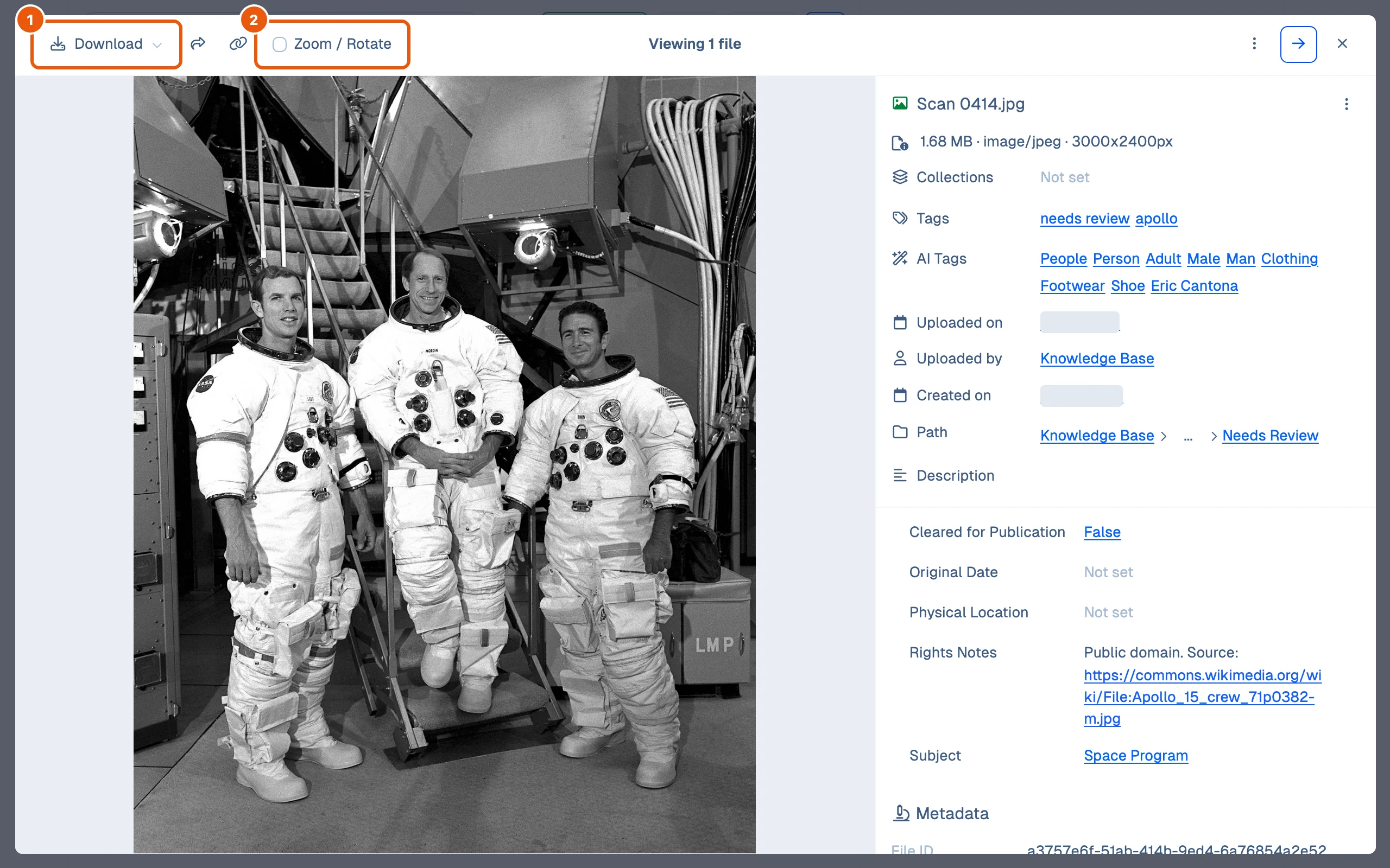 The viewer open on Scan 0414.jpg, a photograph of three astronauts shown upright, with the Download and Zoom / Rotate controls in the toolbar and the file's details on the right.